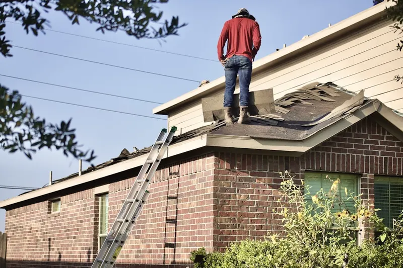 Professional roofer working on a residential roof in Pheasant Run